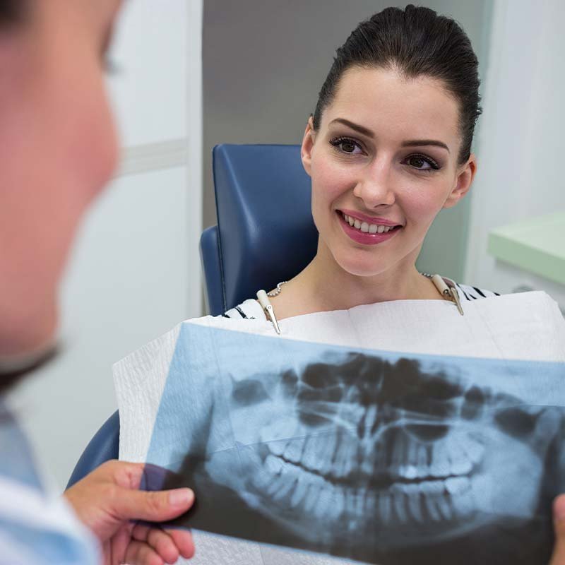 dentist discussing with patient x ray report Miami Dentists